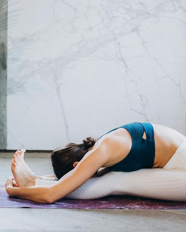 Woman in a calm, seated yoga pose, embodying peace and balance.